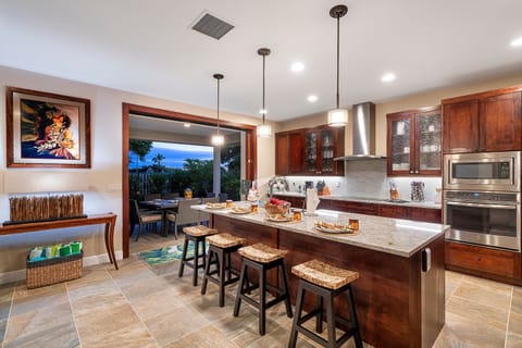 The kitchen includes a breakfast bar with seating for 4.