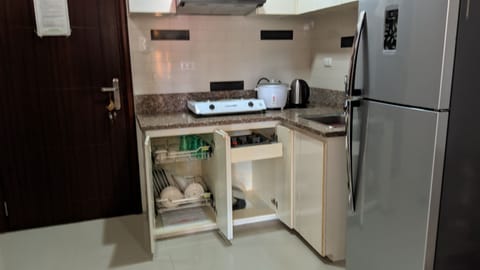 Fridge, electric kettle, cookware/dishes/utensils