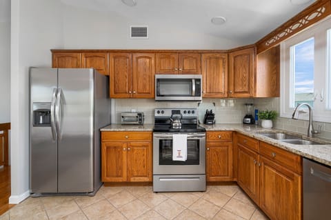 Kitchen with New Appliances: Refrigerator, Microwave, Stove and Dishwasher