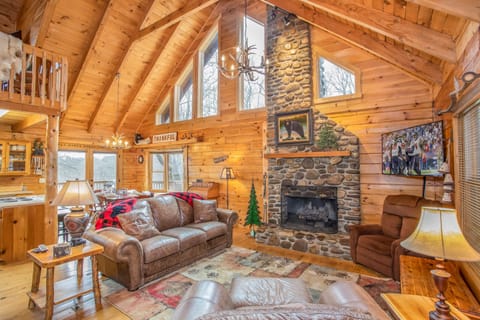 Antler Chandeliers, Vaulted Ceilings with Exposed Beams,  and Wood Floors in Open Concept Main Level