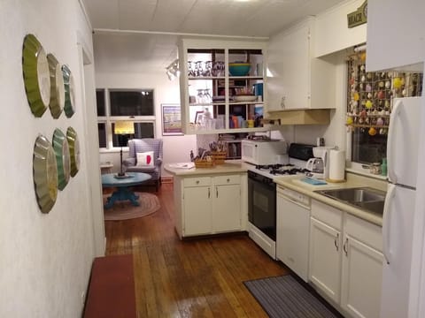 Modern kitchen appliances include refrigerator, dishwasher, range, & microwave.