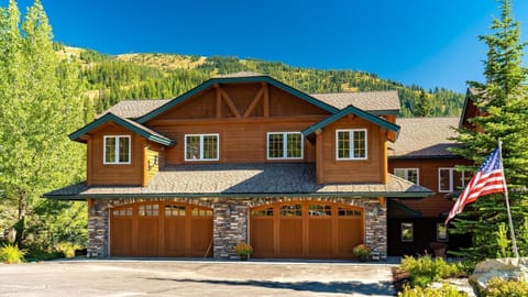 Exterior of home with private two car heated garage and ski access directly out the back door.