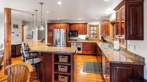 Fully stocked open concept kitchen with breakfast bar seating for 4, two ovens, gas stove, brand new appliances, drip pot coffee maker, and pantry.