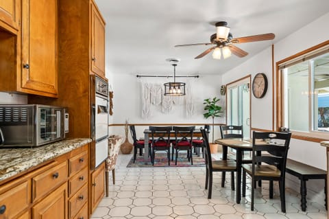 From the kitchen the dining table is set up that seats 6 and with a high chair.