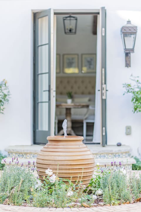 Greek fountain among roses and lavenders greet you at the door