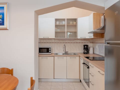 Furniture, Kitchen, Kitchen Appliance, Interior Design, Major Appliance, Countertop, Wood, Flooring, Cabinetry, Floor