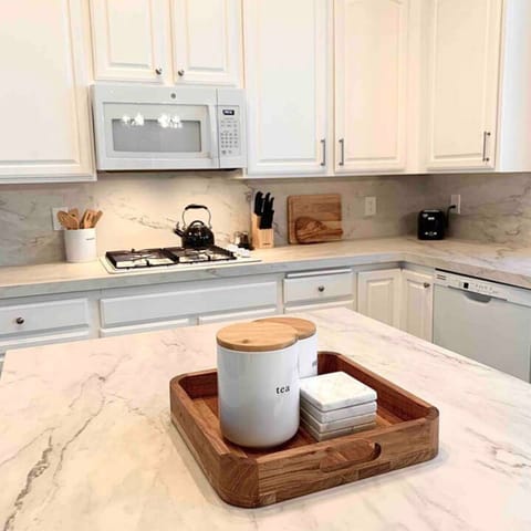 All white kitchen with porcelain countertops and new appliances. 