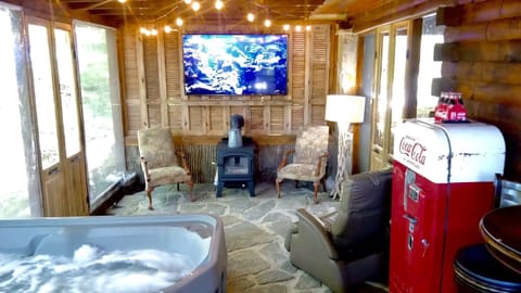 Screened porch with 2 person hot tub , huge smart TV, and wood burning fireplace