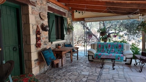 Access is from a covered veranda, with comfortable sofa for lazing about
