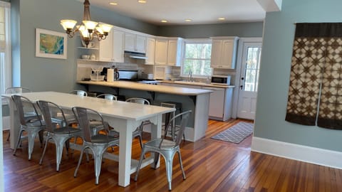 Open kitchen and dining for 8, counter stool seating for 4.