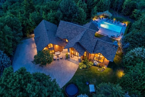 Twilight aerial view of the private estate, surrounded by lush forest