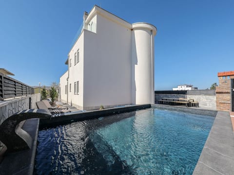 A heated pool, sun loungers