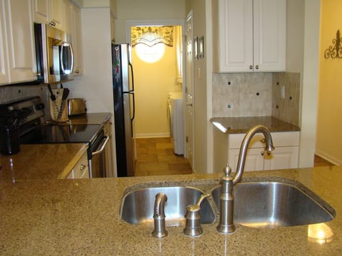 Kitchen with attached laundry room.