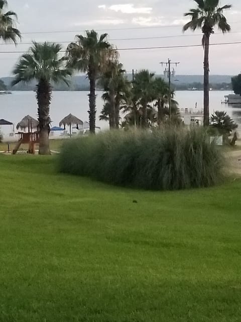 Viewing playground, beach and lake from open lawn