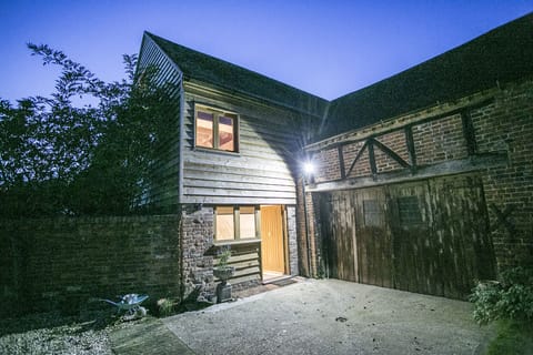 Night time view of the apartment and the courtyard in front of it.