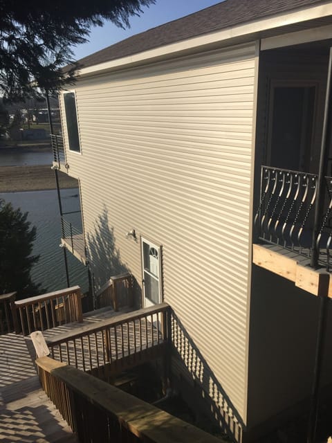 Side view and stairs down to lower level and on down to boat dock 