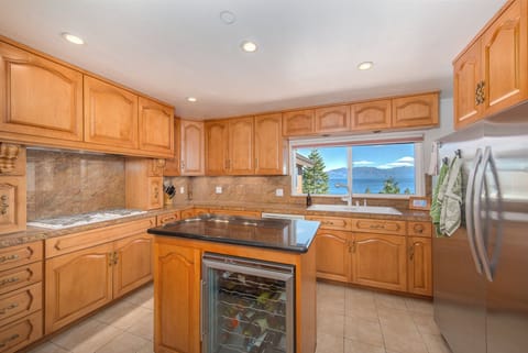 Kitchen features double oven, large refrigerator, 5 burner gas stove, microwave