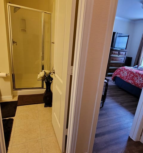 The bathroom is located right next to the bedroom.