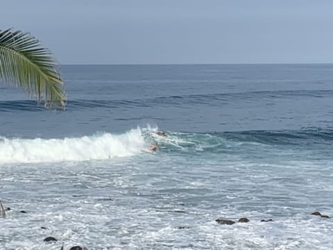 When the waves are right surfers for our entertainment.