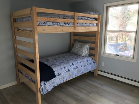 Upstairs bedroom offers bunk beds and one additional twin