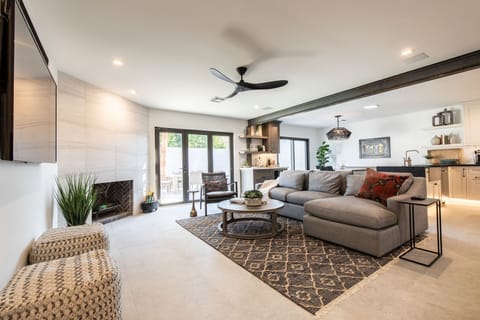 Walking from front door into the living room. Notice the large 2'x4' tiles