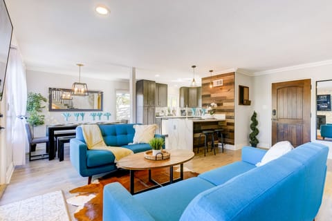 Living room, dining room, kitchen. Open concept, urban, lively, rustic modern.