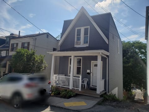 Front of the house, porch and entry. Parking on the street and in the back.