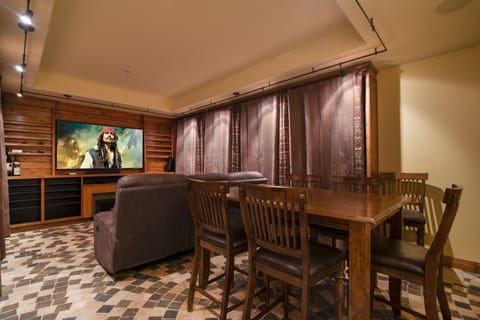 Downstairs you will find a theater room with comfy seating and high top table
