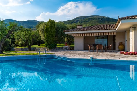 Pool with lovely view of mountains behind house