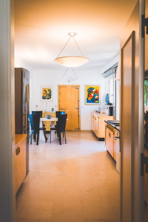 Kitchen with eating nook for four and view of hills and sea from there