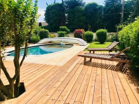 Outdoor swimming pool with wooden deck 