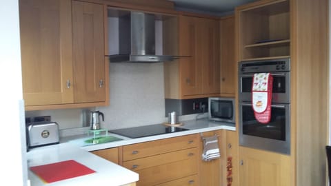 The recently refurbished kitchen has attractive light oak units