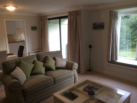 Living room view to balcony and loveseat