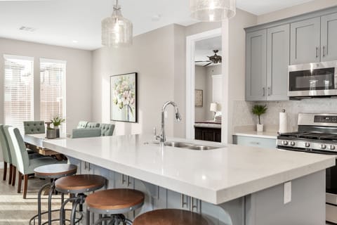 Fully stocked gourmet kitchen featuring extra seating at the bar