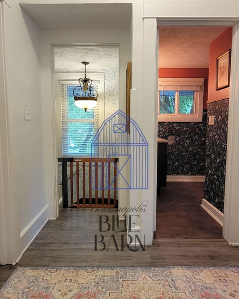 View of upstairs bathroom and baby gate for stairs.