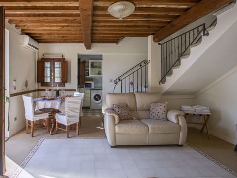 Furniture, Property, Ceiling Fan, Cabinetry, Table, Couch, Lighting, Picture Frame, Wood, Countertop