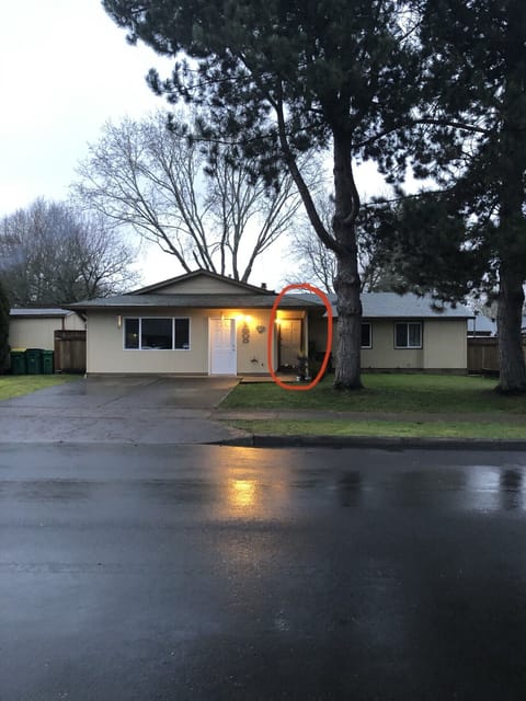 Home is fenced in with driveway guest parking. Red circle indicates front door