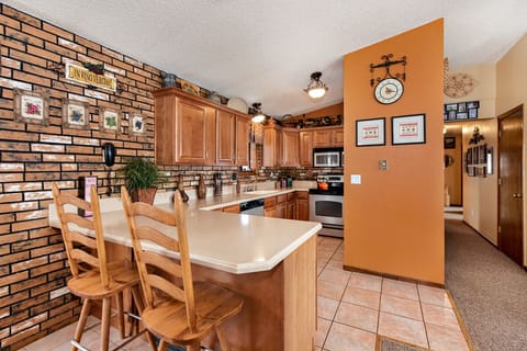 Kitchen, bar and hallway leading to bedrooms