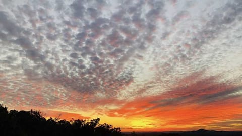 The restful quiet of the Hill Country is silhouetted in beautiful contrast against fiery sunsets.