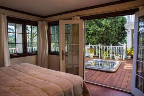 Hot tub is set in the wraparound deck outside the bedroom french doors