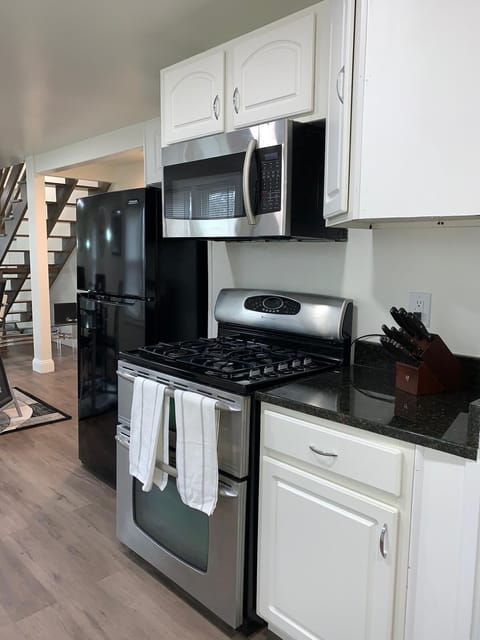 Kitchen is equipped with basic utensils and cleaning supplies.