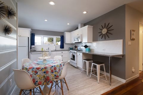 Kitchen within dining table for 4 with additional counter top bar height seating