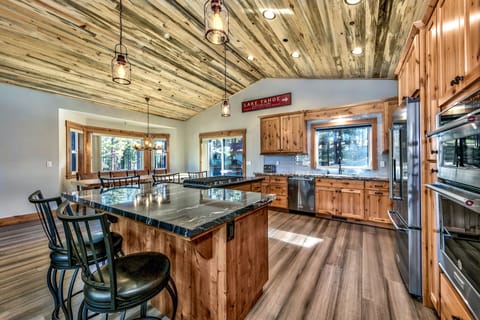 The kitchen has a 5-burner gas range, french door fridge & bottom freezer, and much more