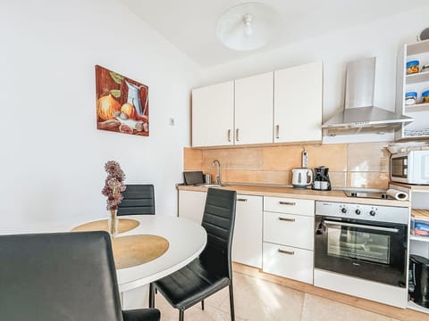 Furniture, Interior Design, Flooring, Wood, Floor, Room, Countertop, Cabinetry, Table, Chair