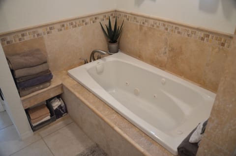 Bathtub, jetted tub, hair dryer, towels