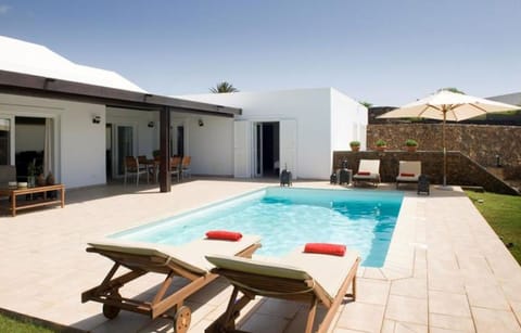 A heated pool, sun loungers