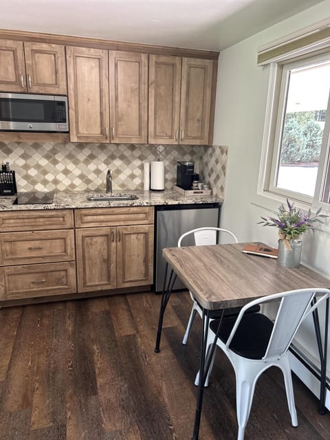 Mini Kitchen with fridge, microwave, one induction burner, toaster, k-cup coffee maker with k-cups, sugar and cream