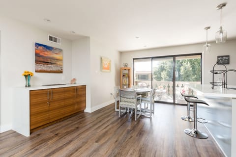 Open floor plan featuring the dining table set to accommodate four guests.