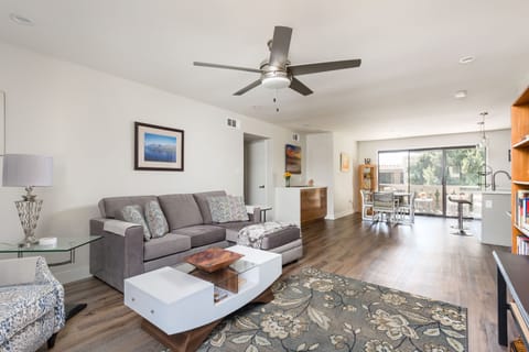 Modern open floor plan featuring a designer furnished living room with a flat-screen SMART TV overlooking the fully equipped kitchen.