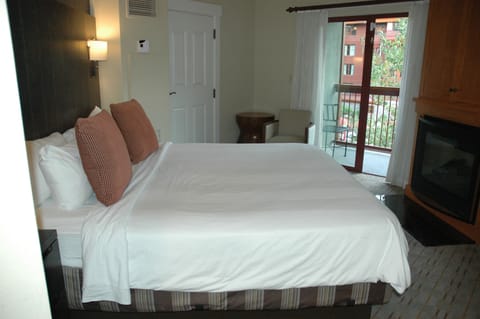 King size bed in Master suite with balcony & fireplace.